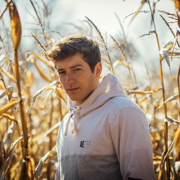 Person meditating in a serene natural environment with golden light.